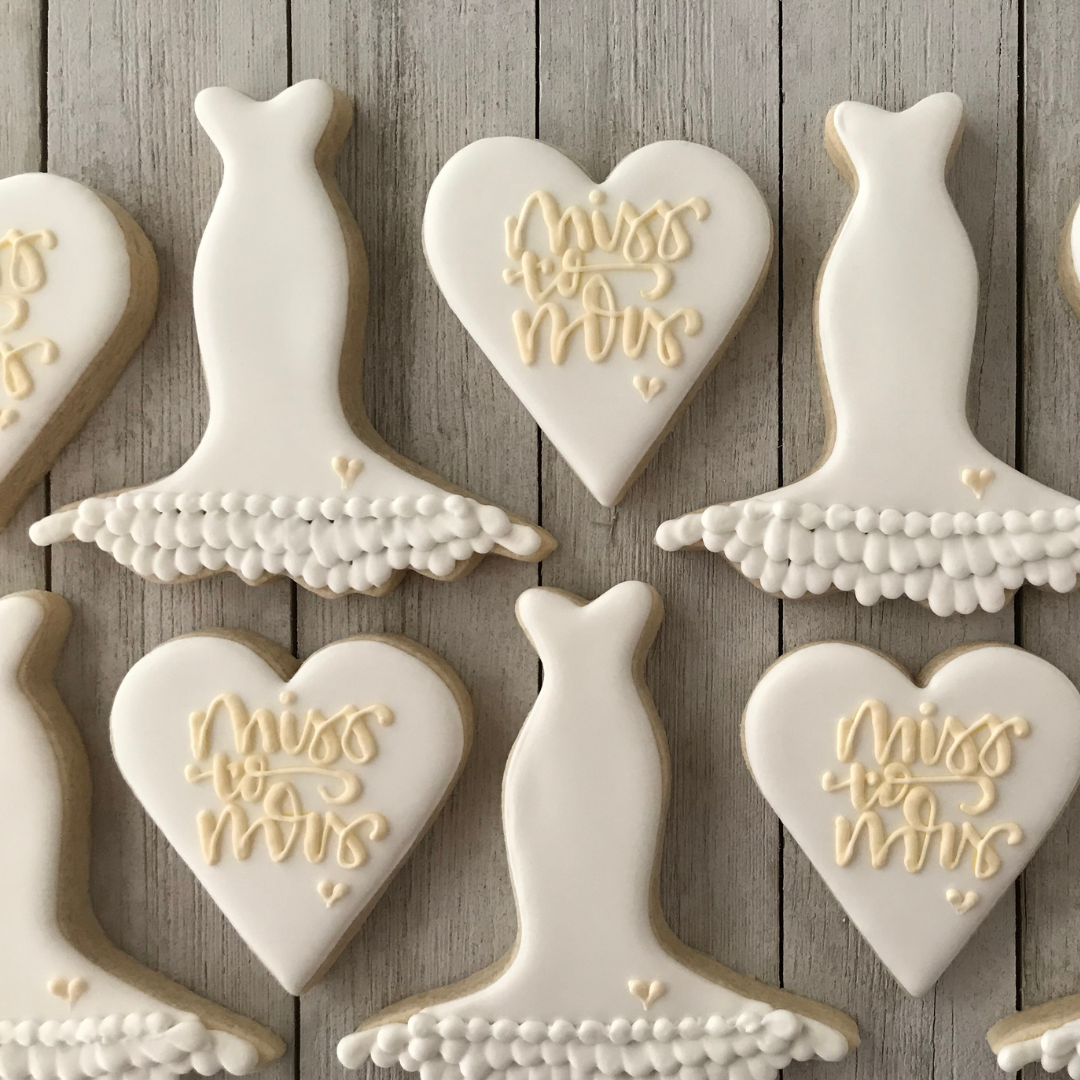 How Many Cookies Per Person at a Wedding - cookies shaped in hearts and wedding gowns displayed on tray