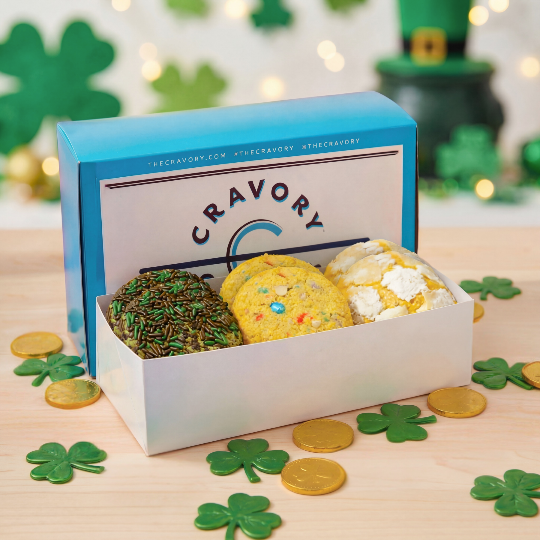 Box of cookies with Cravory branding on a table with St. Patrick's Day decorations.