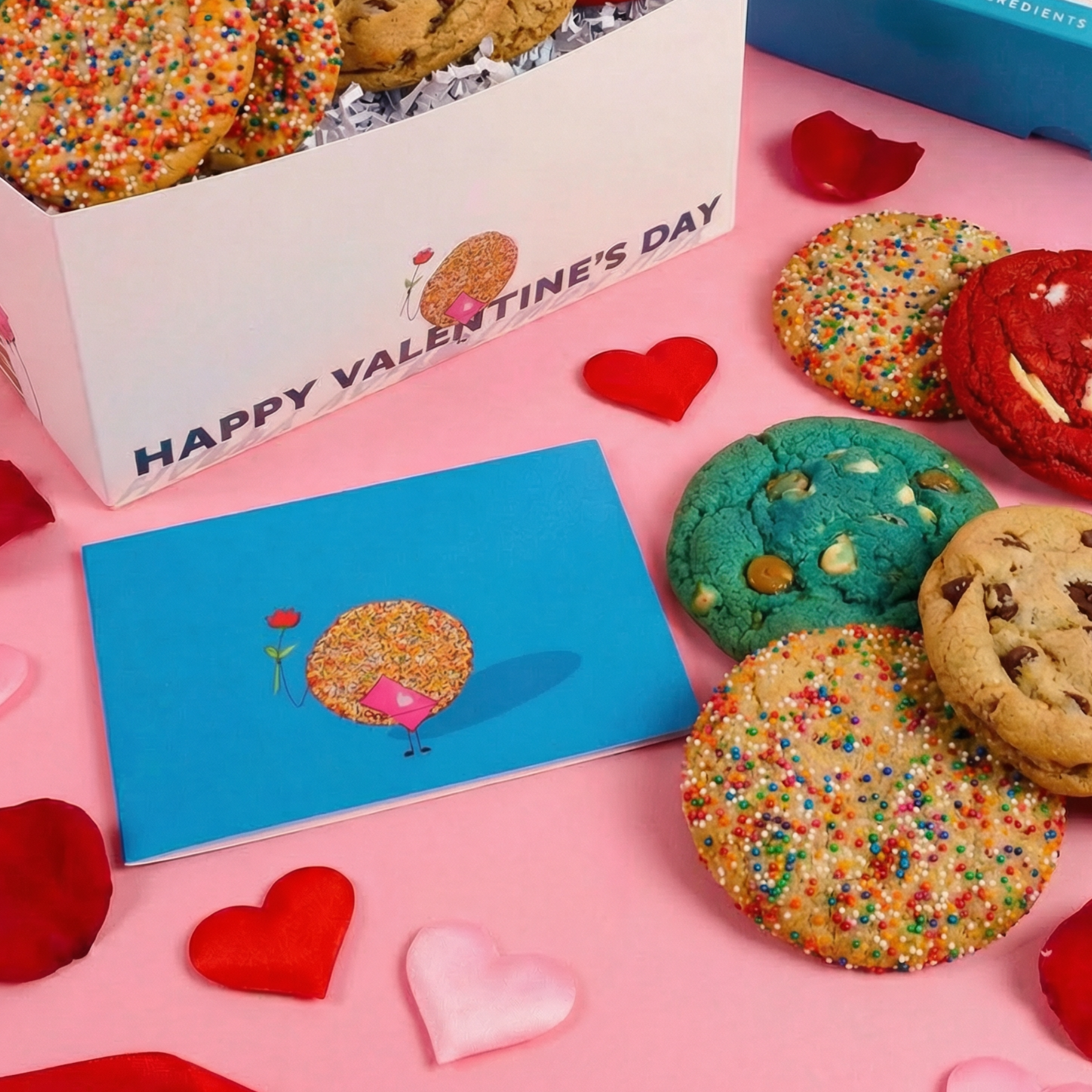 Colorful cookies with a Valentine's Day card on a pink background