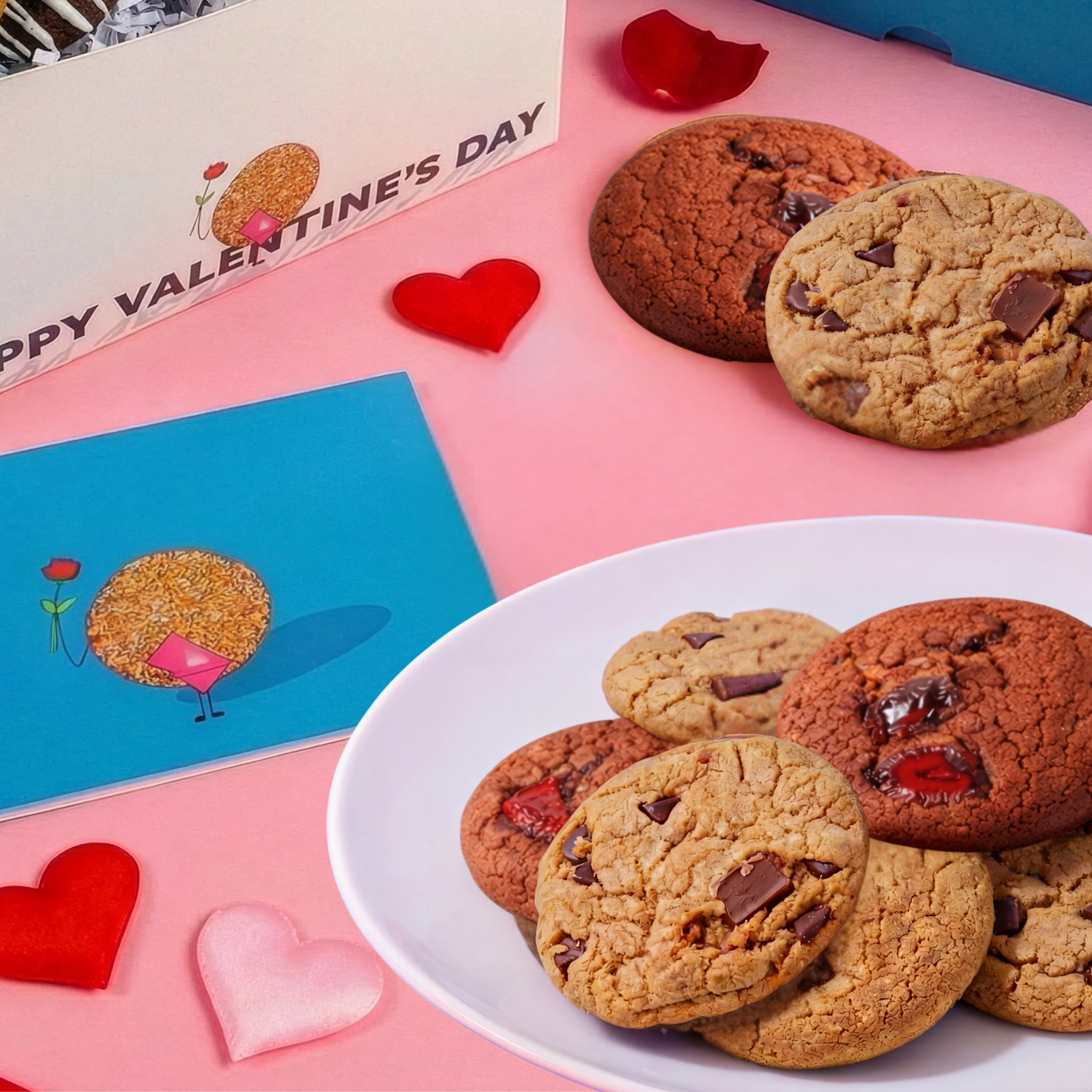 Valentine's Day cookies of the month on a plate with Valentine's Day cards and heart decorations on a pink background