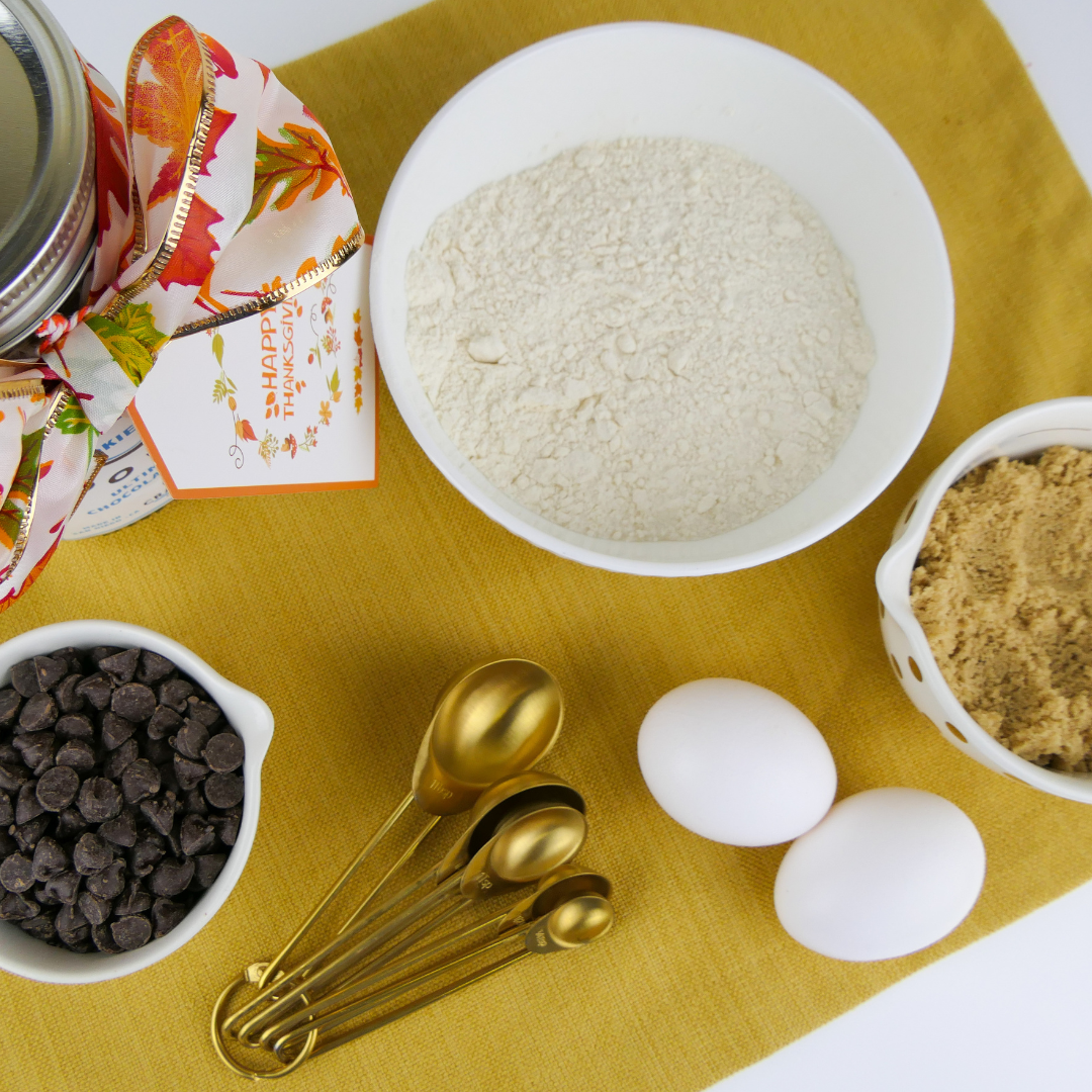 Bowl of flour, chocolate chips and eggs on tray