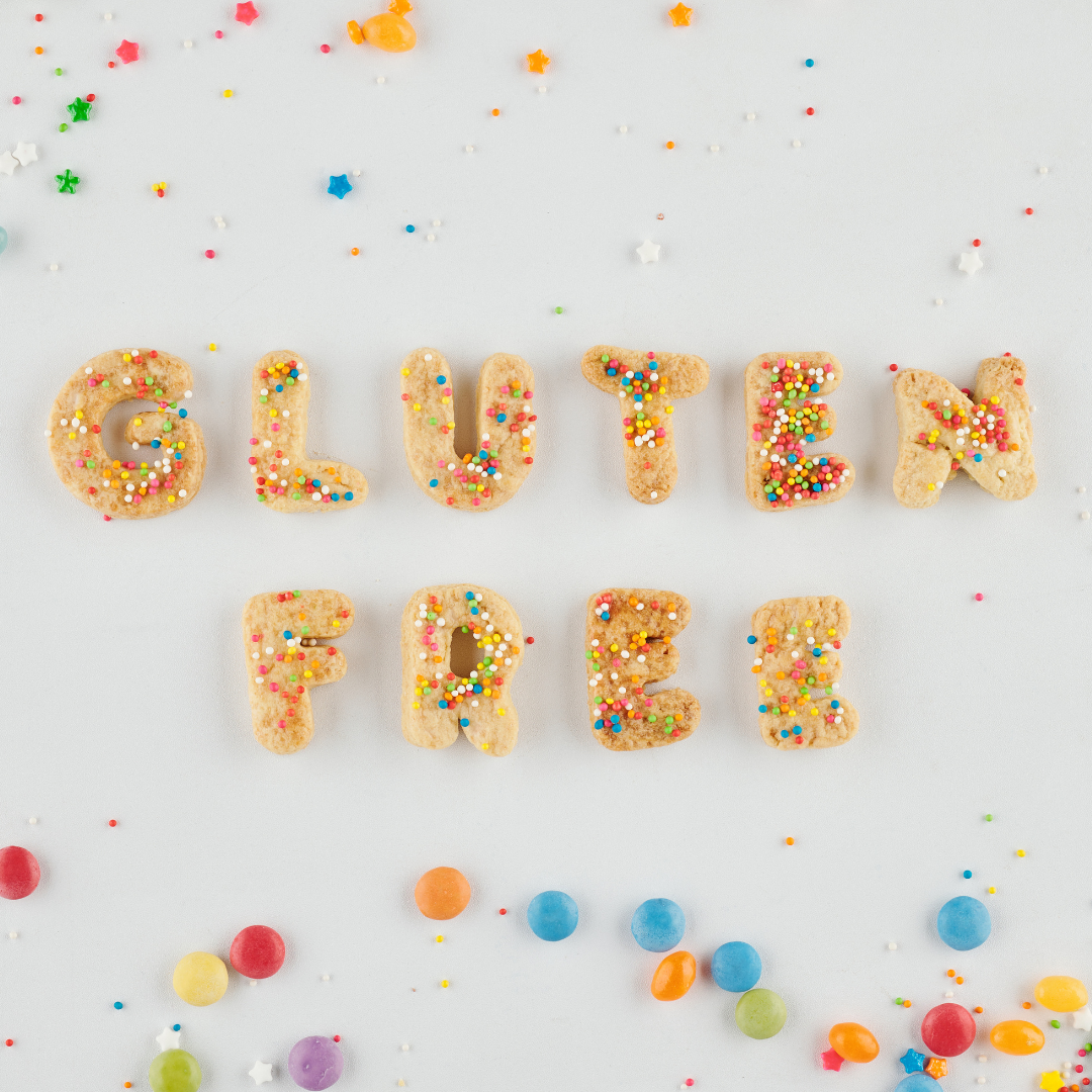 Alphabetical cookies spelled out to read Gluten Free and sprinkled with colorful sprinkles on top.