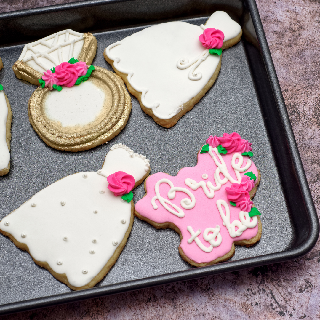 Sugar cookies in wedding shapes on cookie sheet
