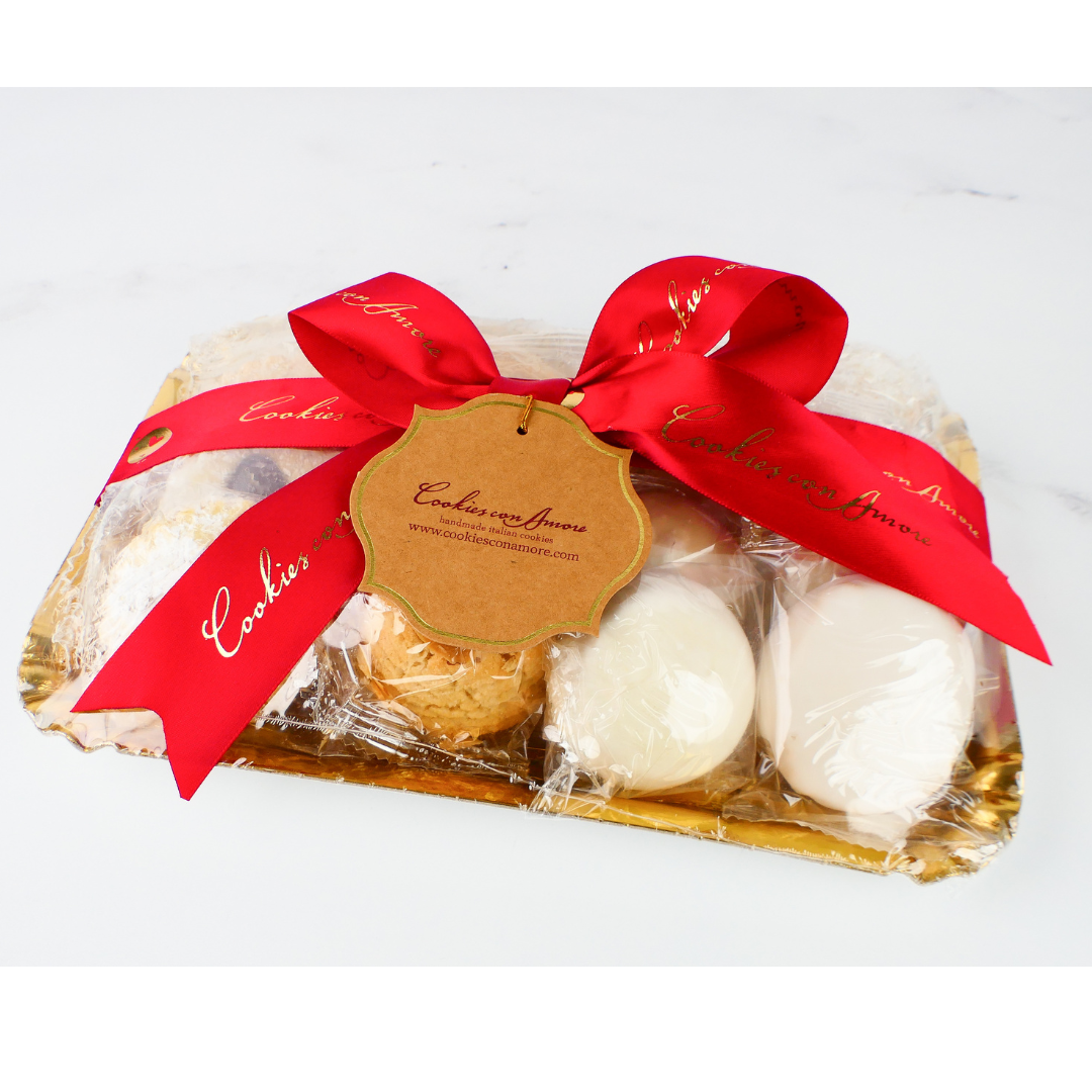 Packaged cookies with a red ribbon and gold tag on a white background