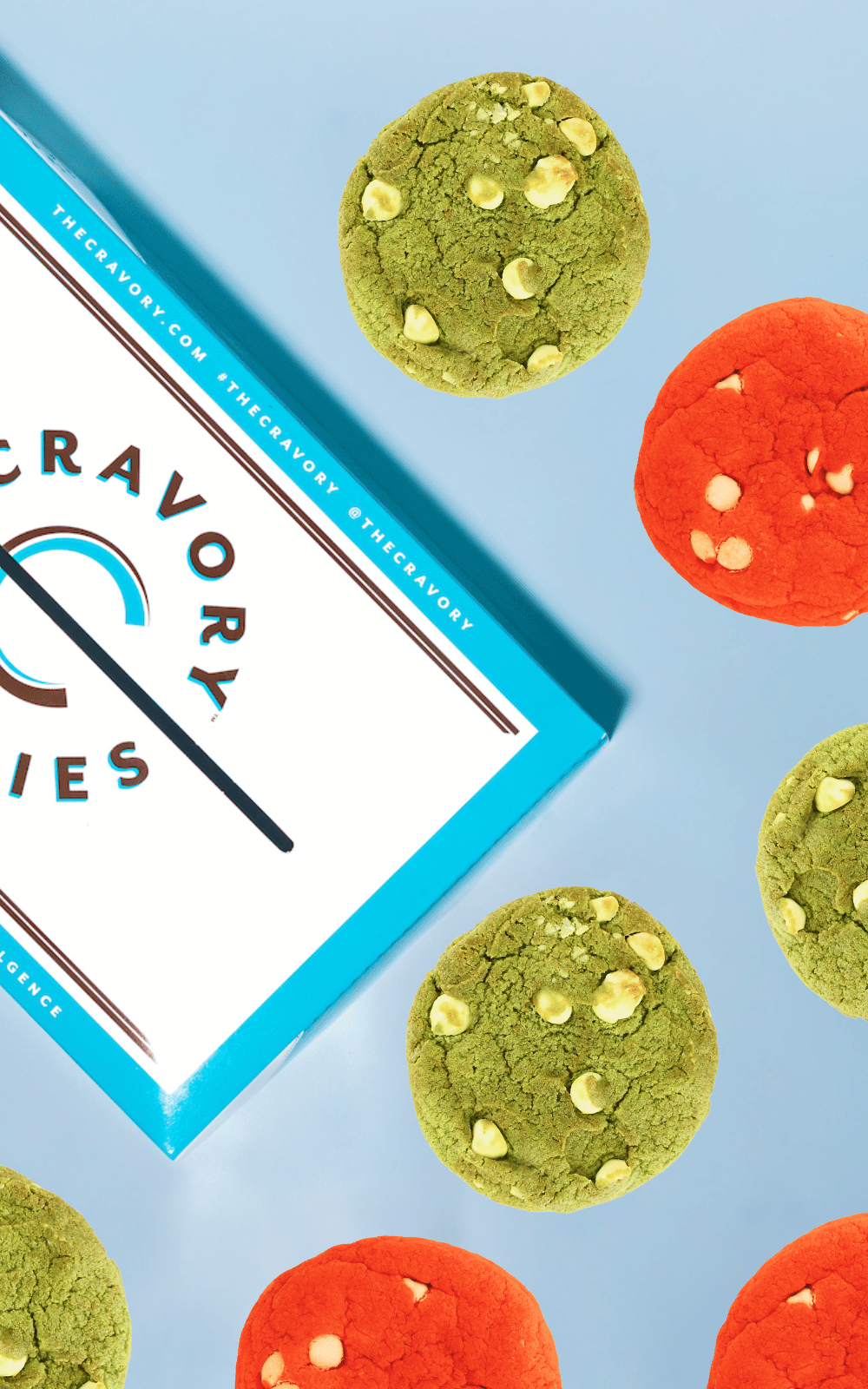 Colorful cookies with a Cravory Cookies box on a blue background